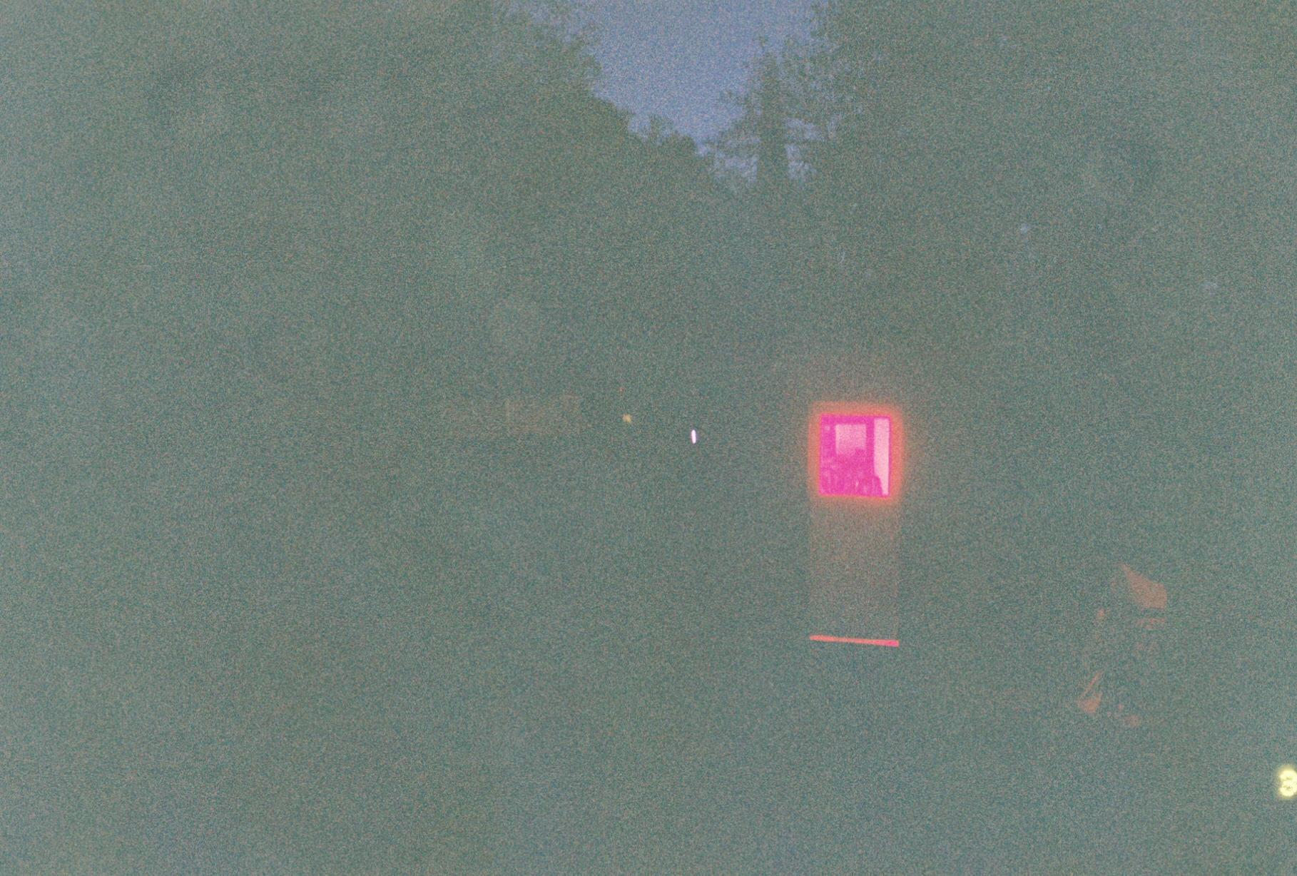 a red light seen through the glass window of a door