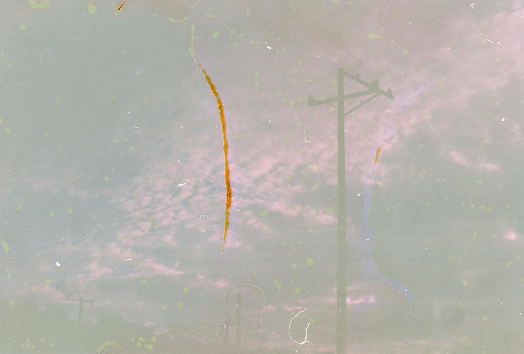 a telephone pole in front of a cloudy sky