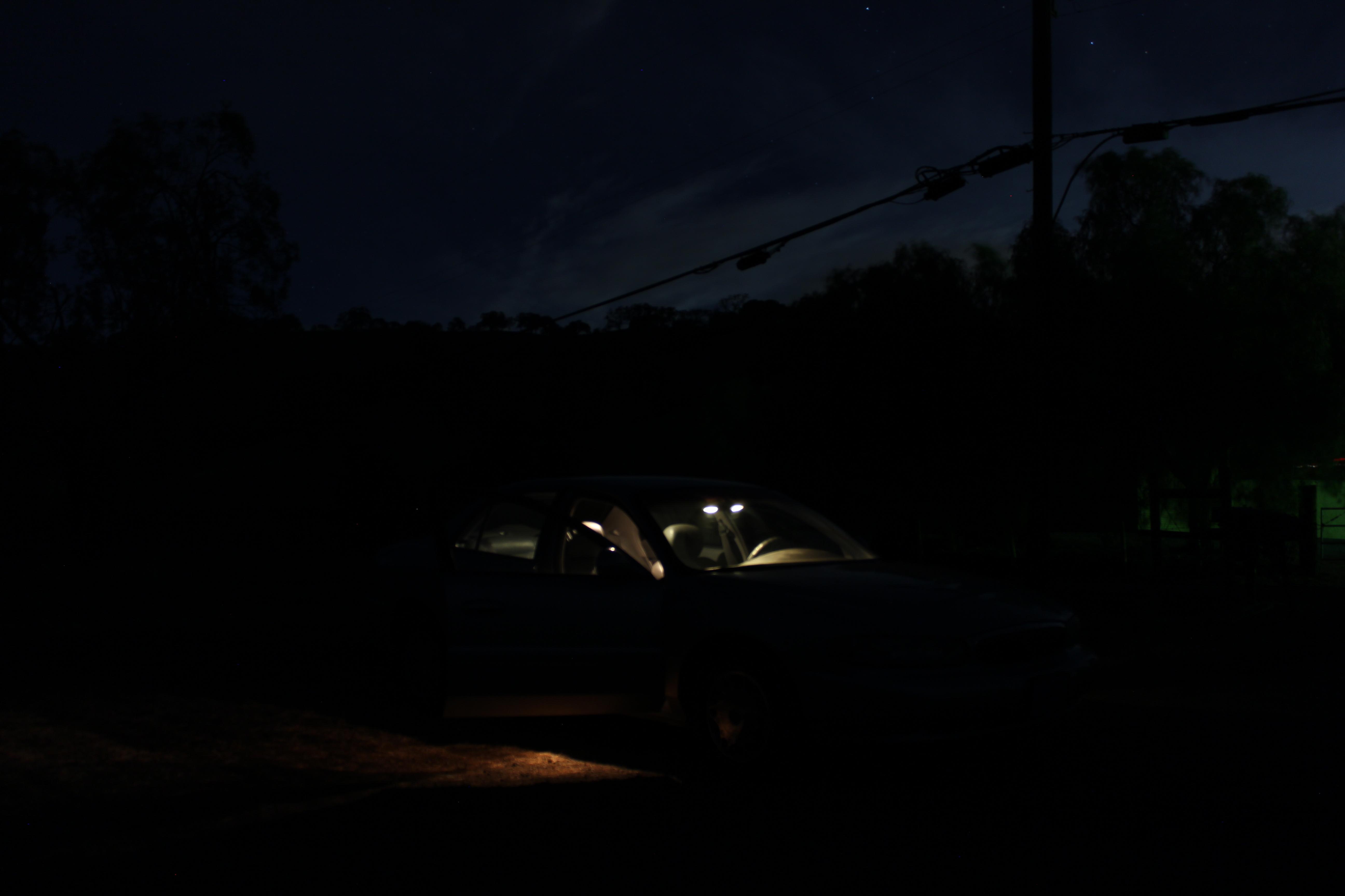 a car lit up on the inside at night