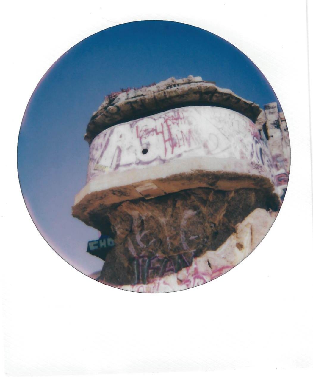 the side of a disheveled cement structure
