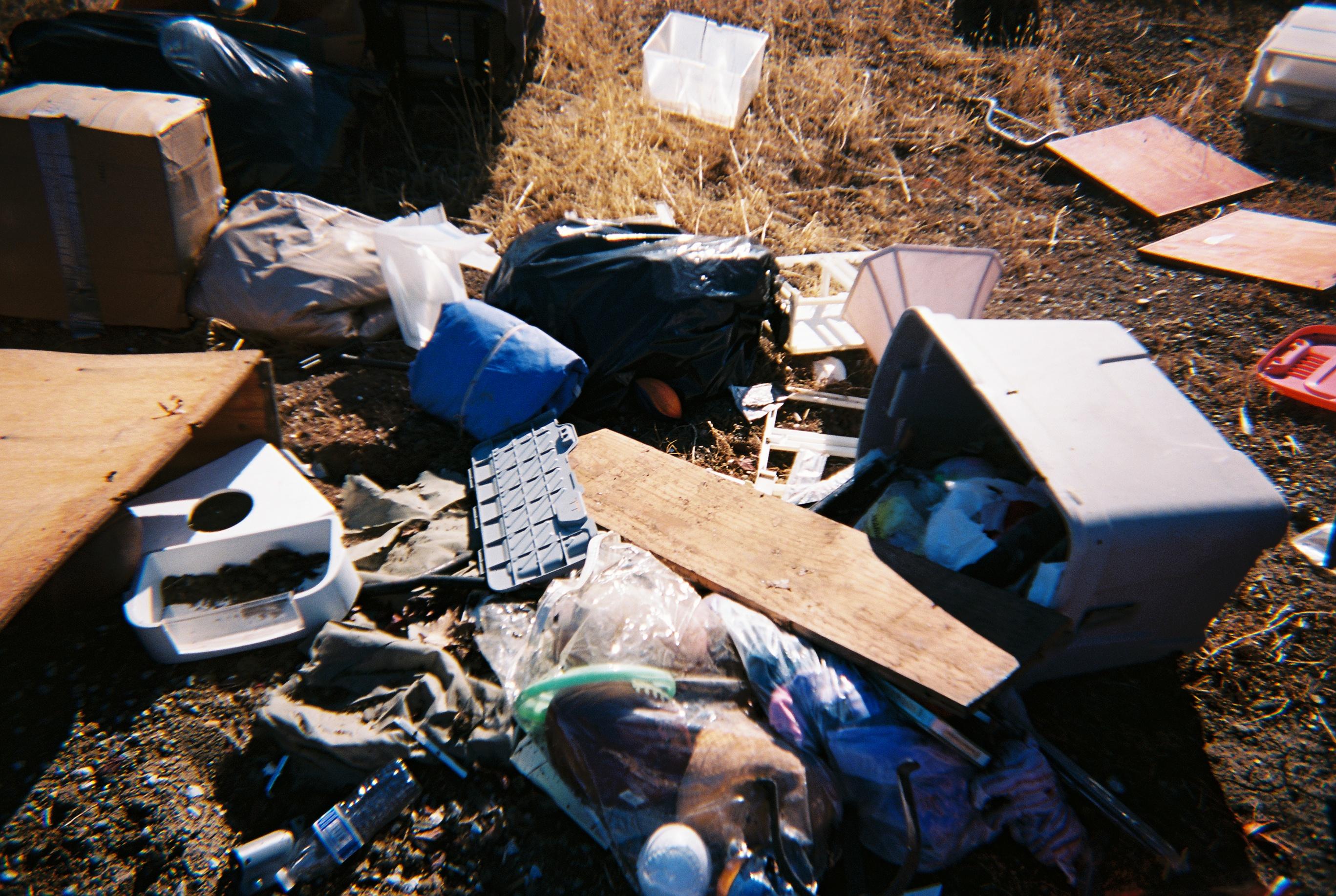 a pile of miscellaneous garbage in the dirt