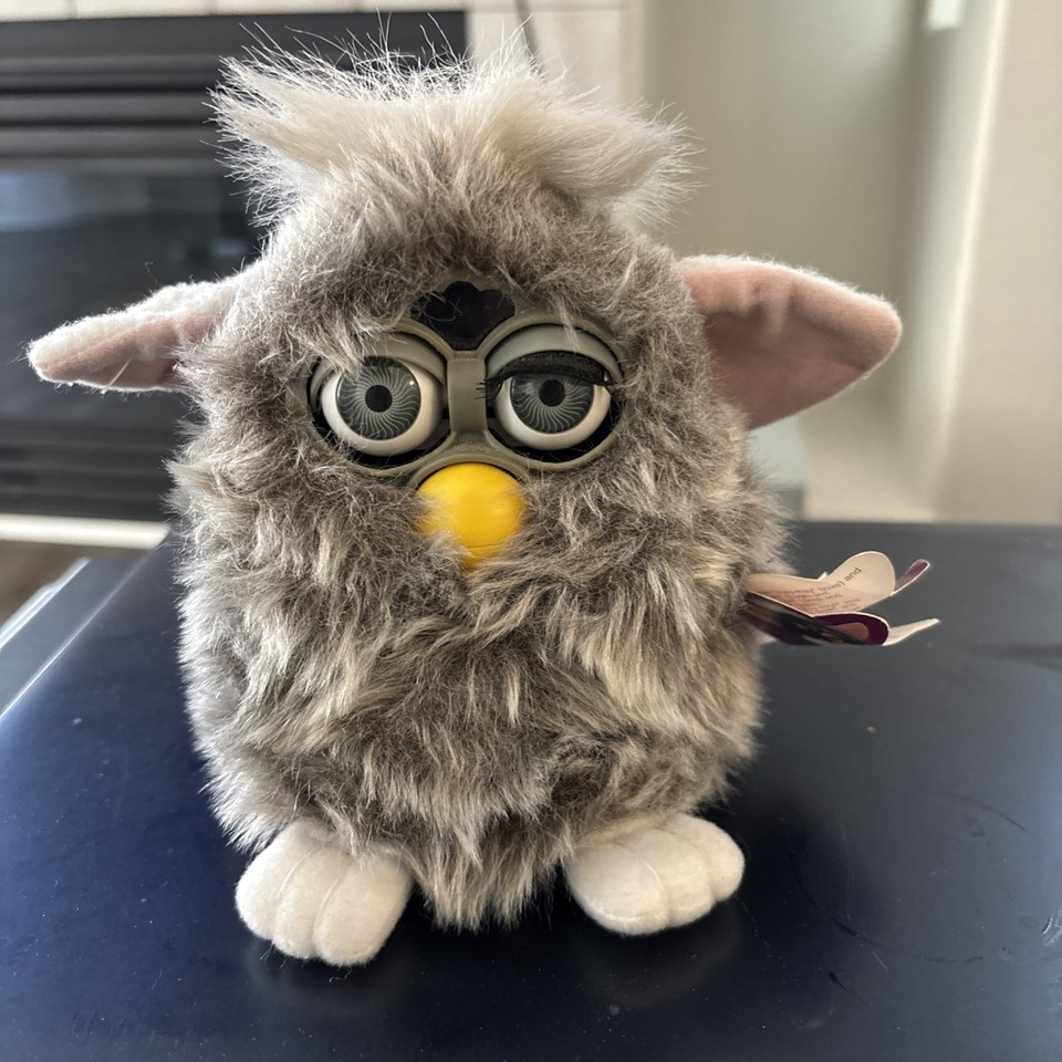 a furby with one half-lidded eye